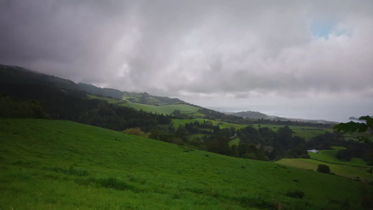 Panoramic view of green lush meadow landscape in the Azores Cloudy dramatic weather