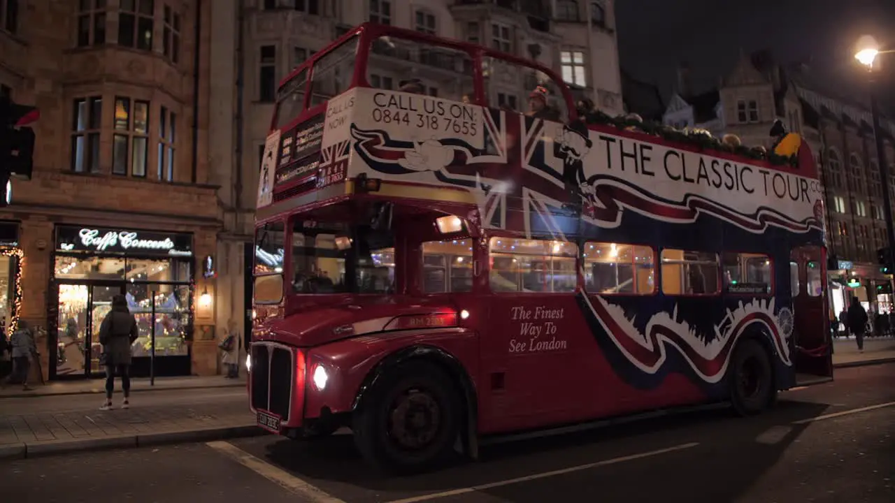 London tourists on classical open top tour bus in Kensington