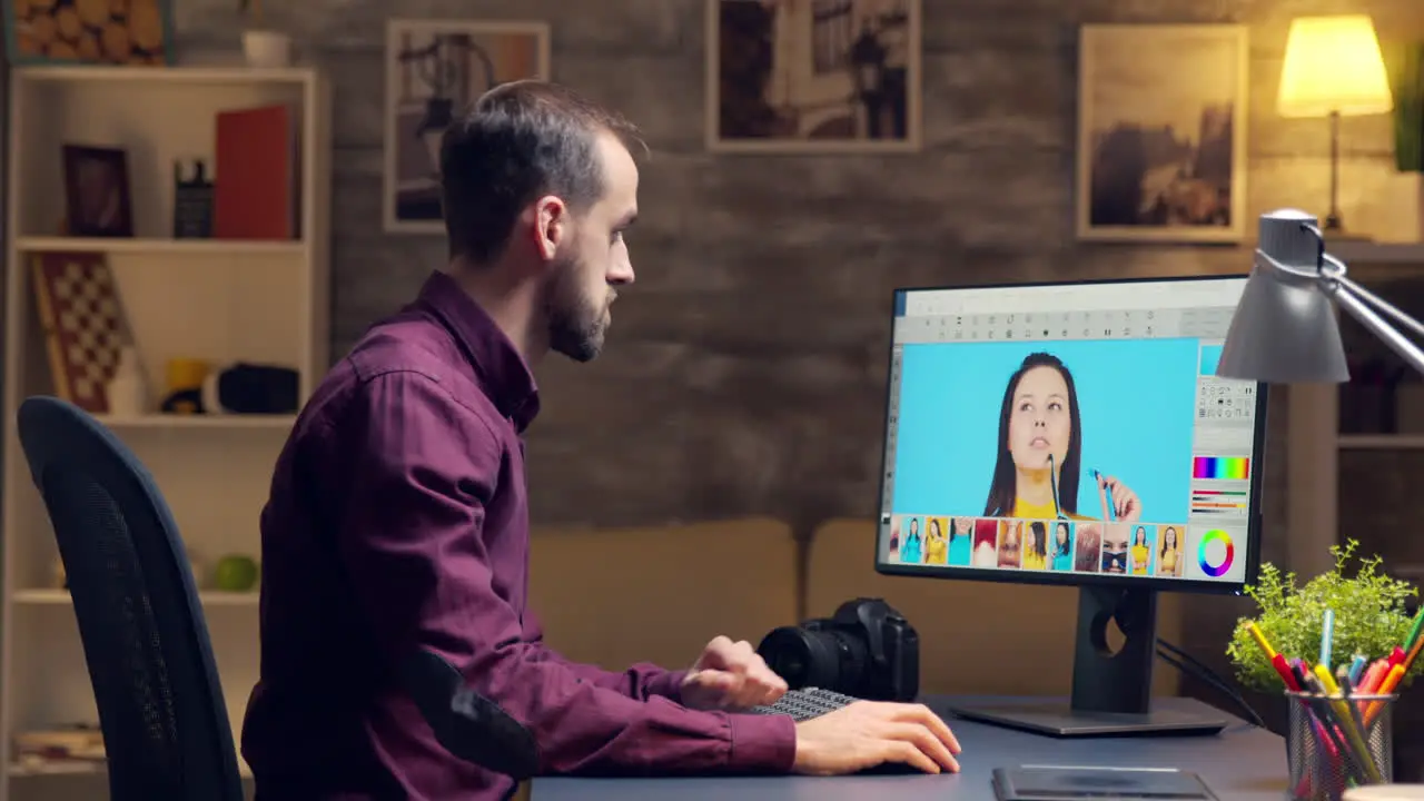 Young creative photographer working on a photo on computer