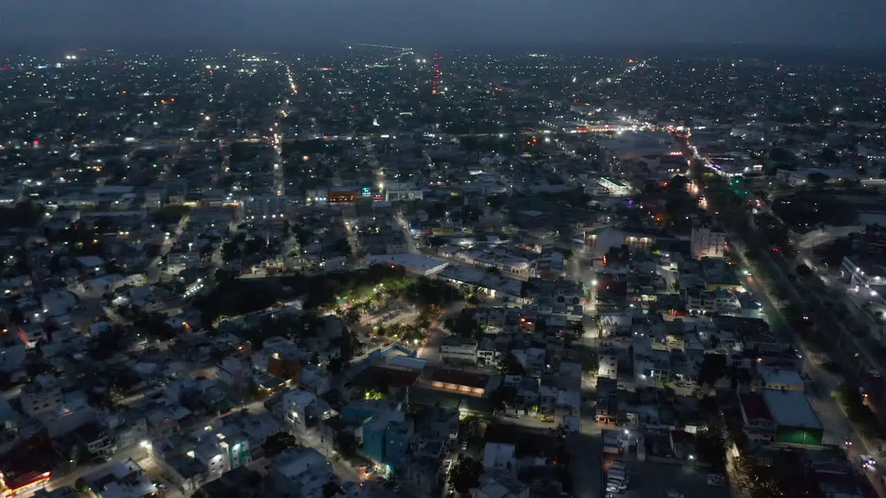 Aerial panoramic view of city after sunset Tilt up reveal of evening sky with clouds Cancun Mexico