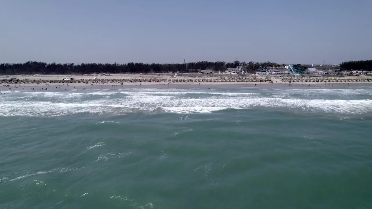 Side aerial view of the waves and the beach of Tampico