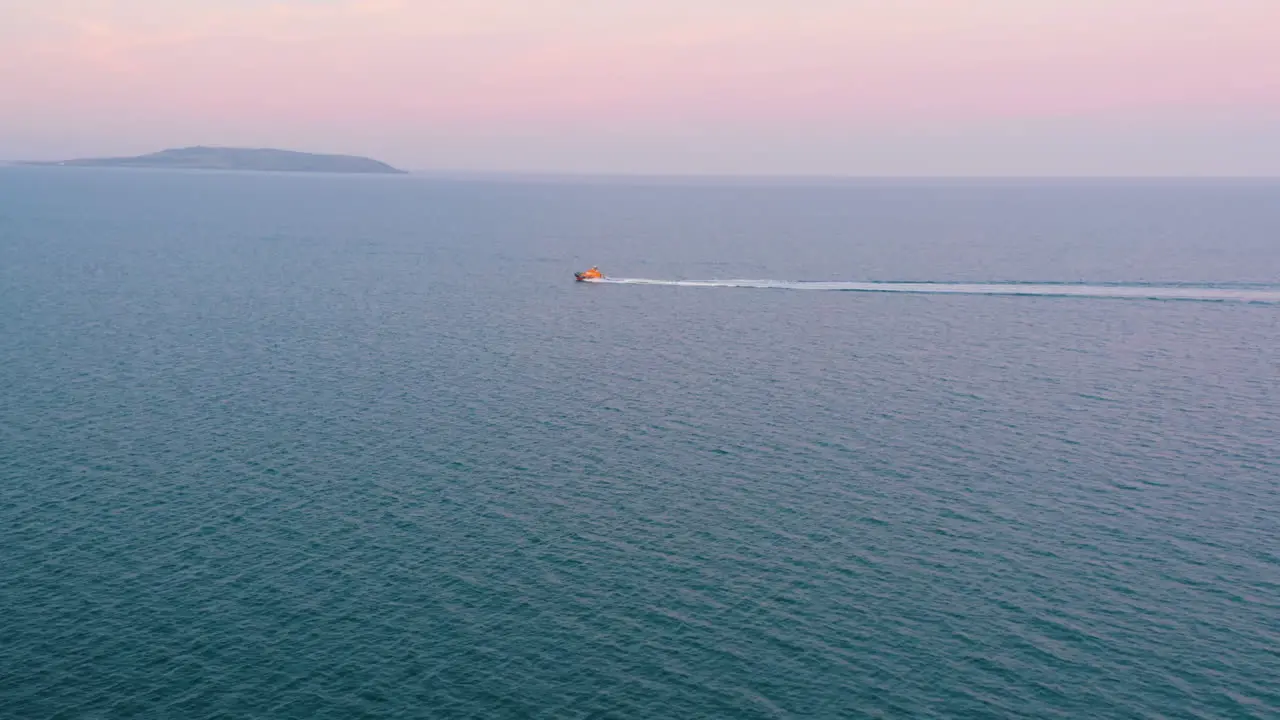 Aerial view shot in 4K following a life boat RNLI on a training mission