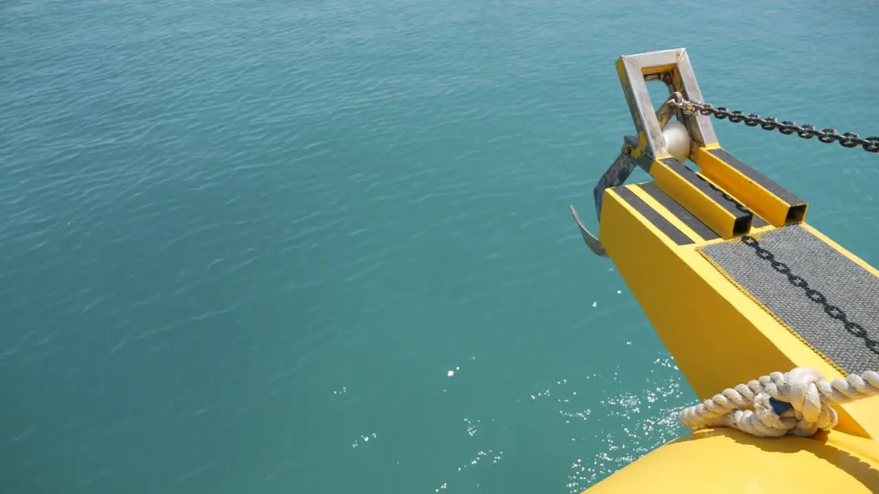 Peaceful view off the front of a boat cruising through sunny clear seas