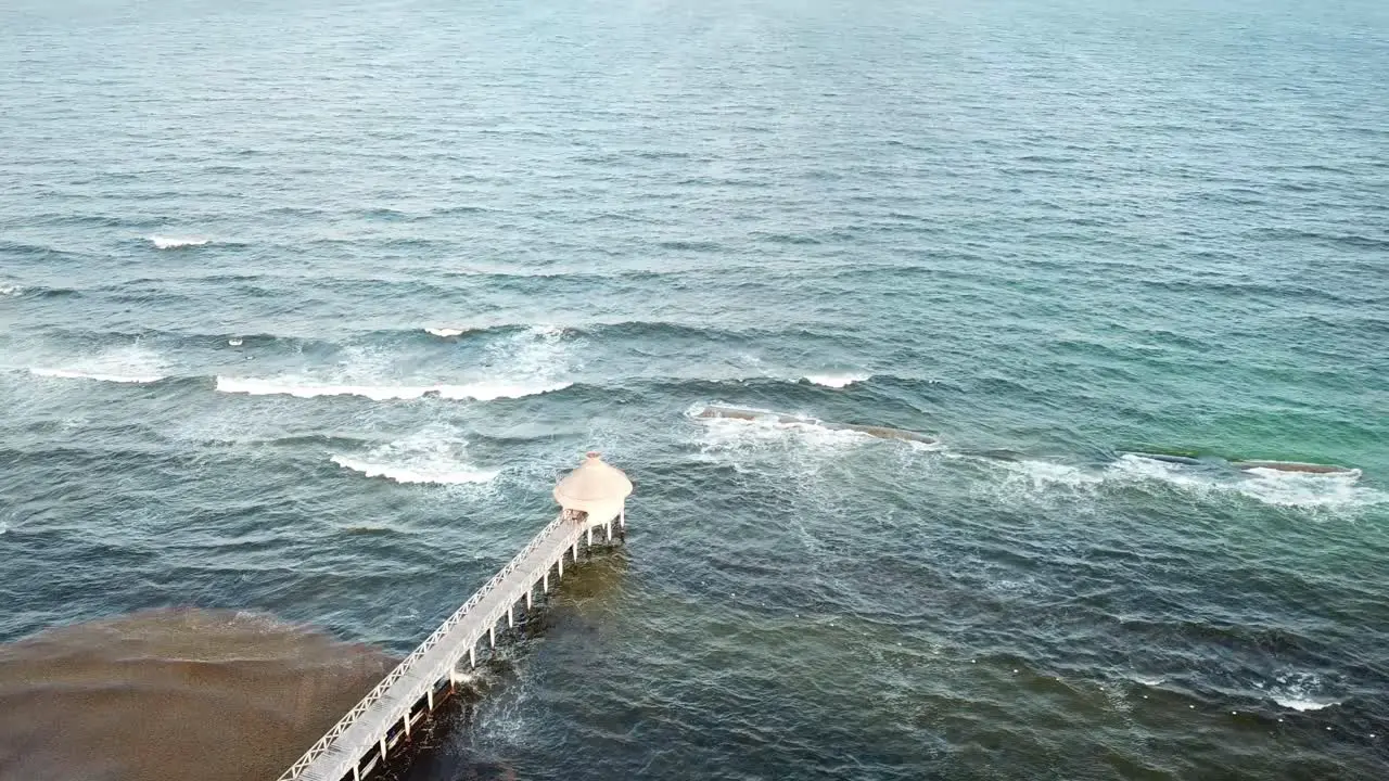 Aerial View Of Fishing Pier In Quintana Roo Mexico With Sea Waves Splashing In Slow Motion