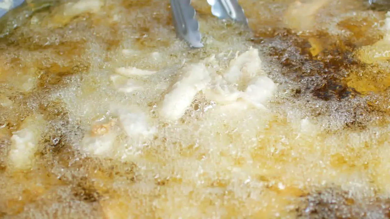 POV to the pan full of fried fresh banana for snack