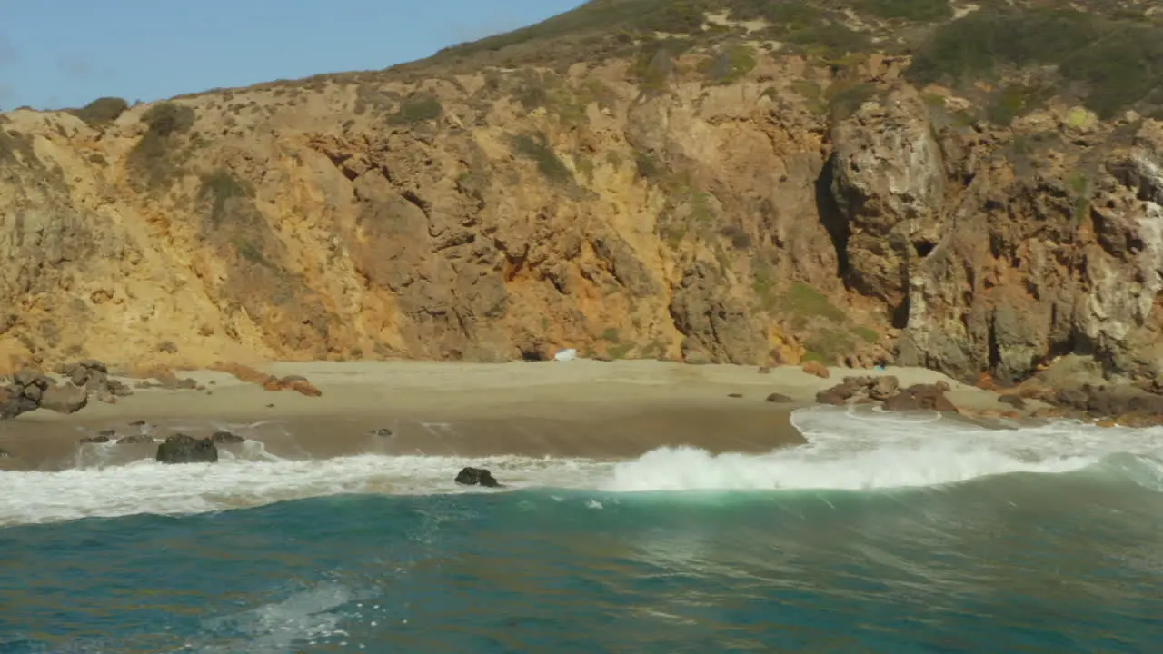 Aerial shot of beautiful beach with cliff