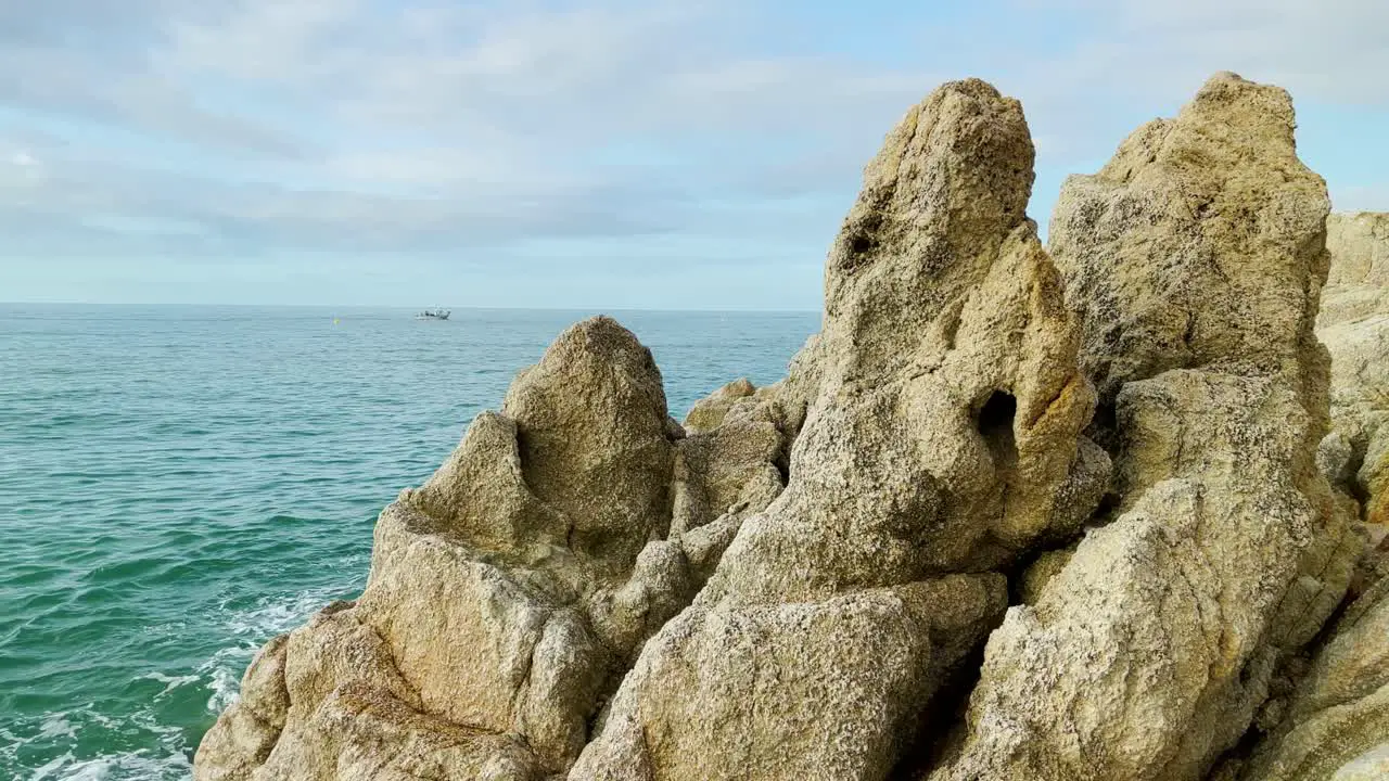 rocks Mediterranean beach without people at sunrise turquoise blue calm water Barcelona coast Maresme Costa Brava Spain European tourism