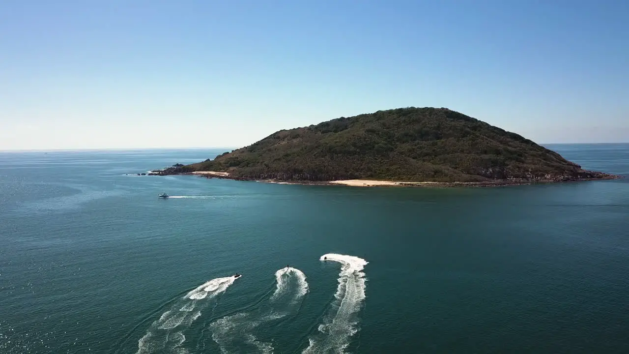 Water scooters sailing to an isolated island in the middle of the sea