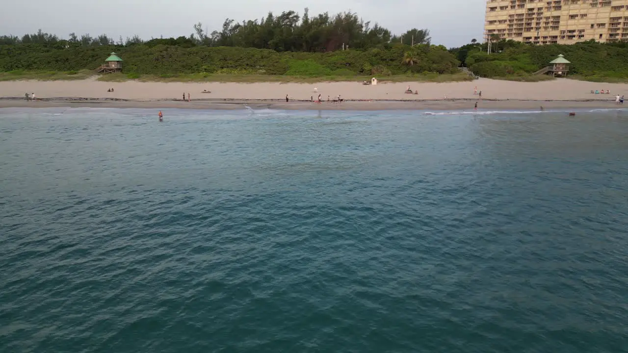 Drone footage shows beachgoers enjoying themselves while strolling