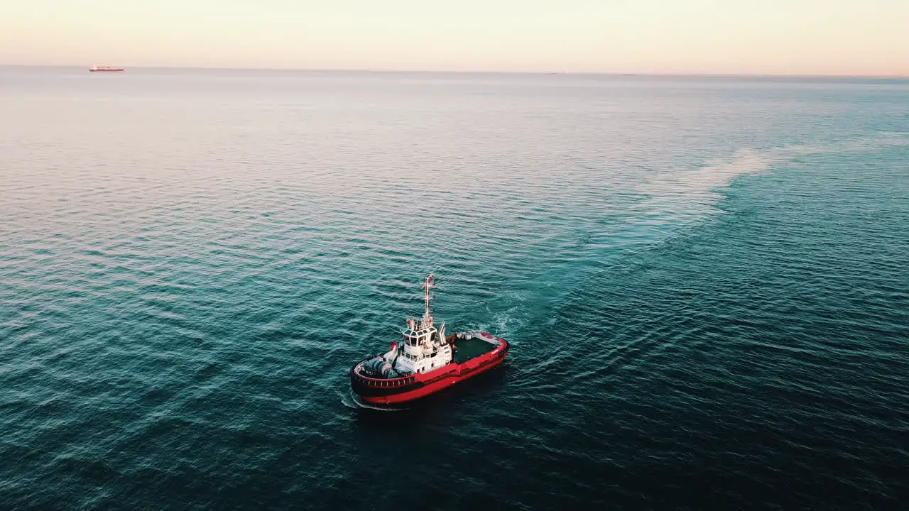 Drone flying over the fishing boat sailing on the sea at the sunset-1