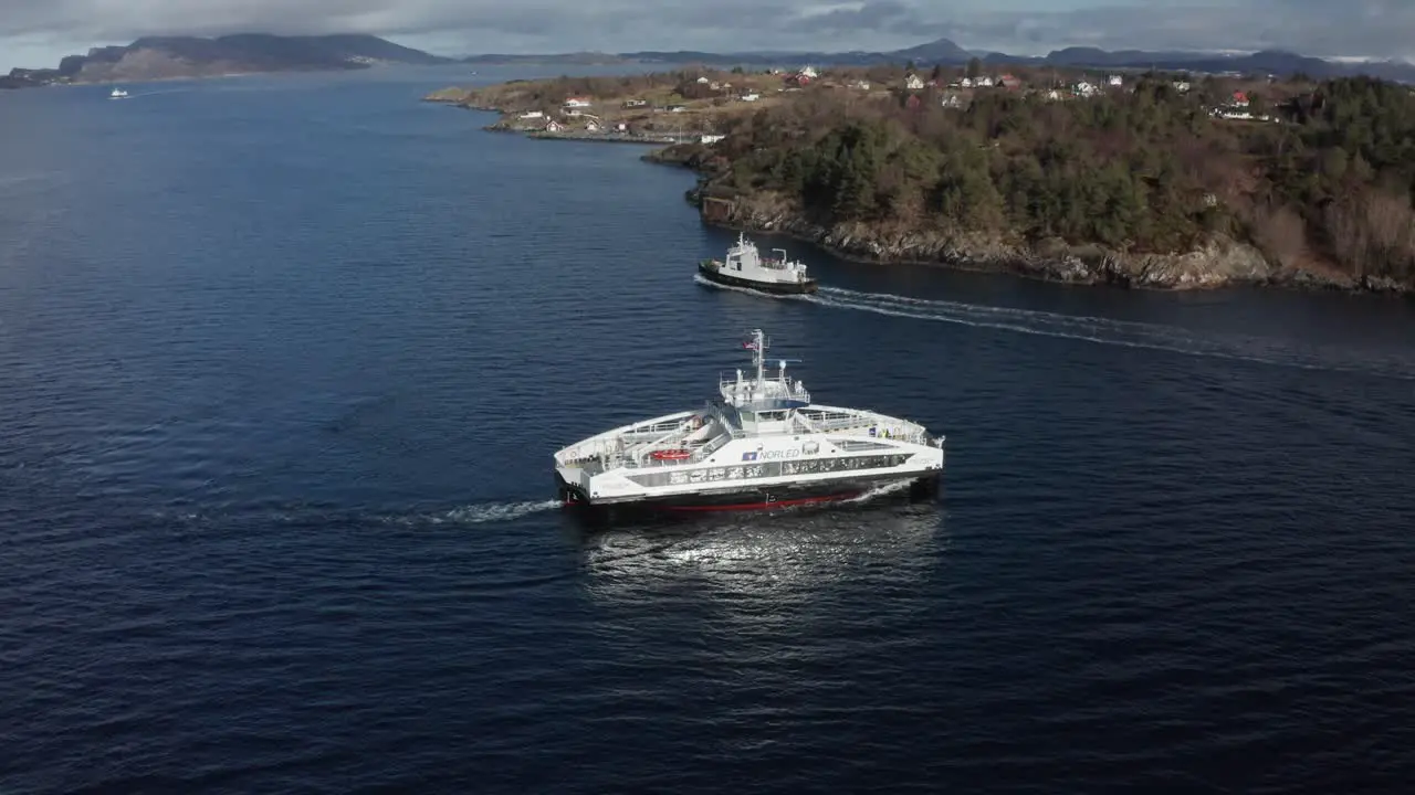 Aerial shot over Electric passenger ferry meeting old diesel ferry from 1968 Norway