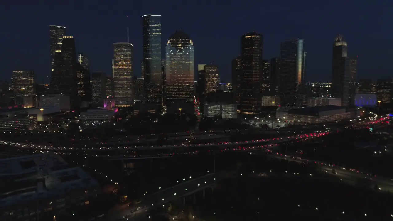 This video is about an aerial view of downtown Houston at night with traffic going pass downtown