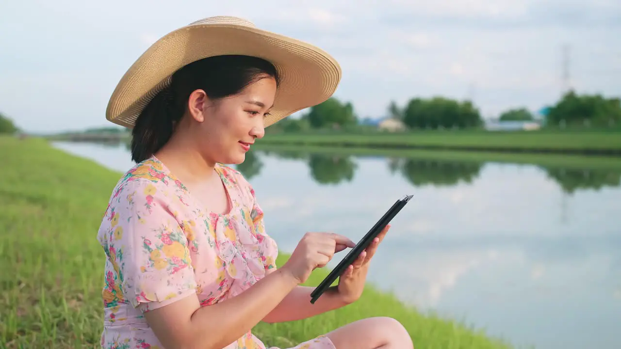 Asian woman using portable device during vacation