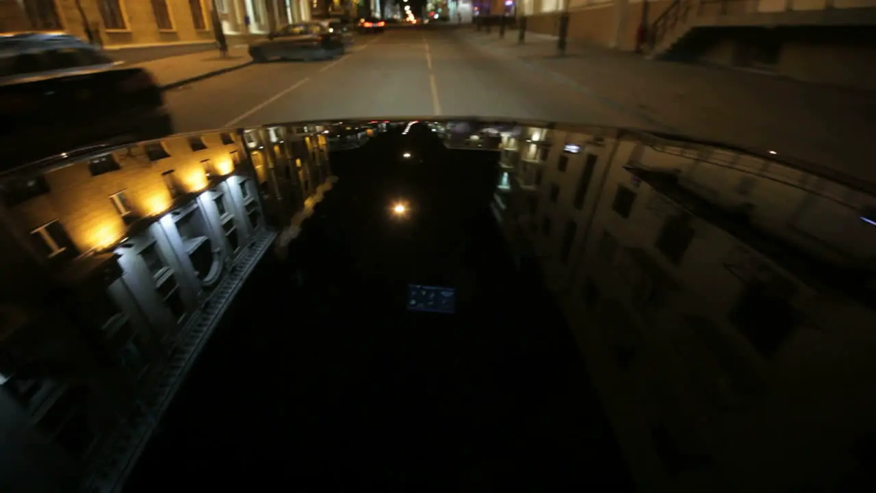 Street lights reflection on car hood at night City lights reflections on car