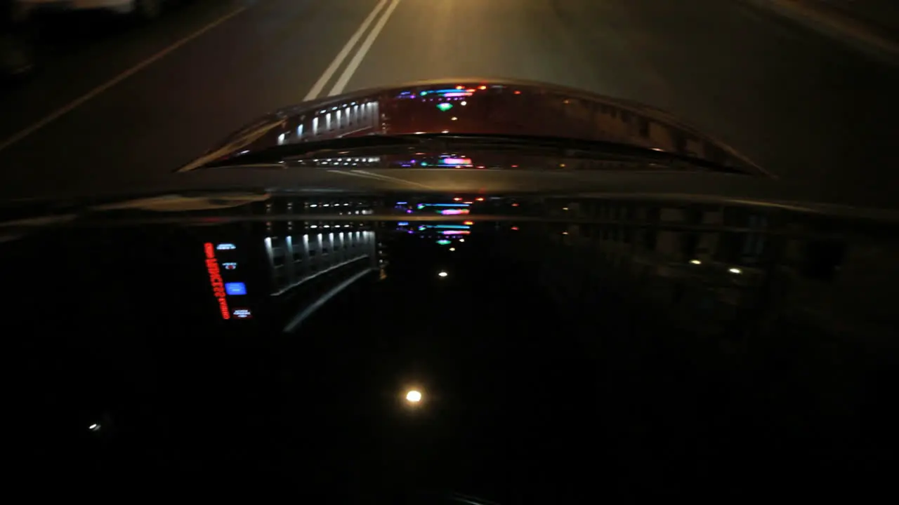 Street illumination on car hood Light reflections on car glass and hood