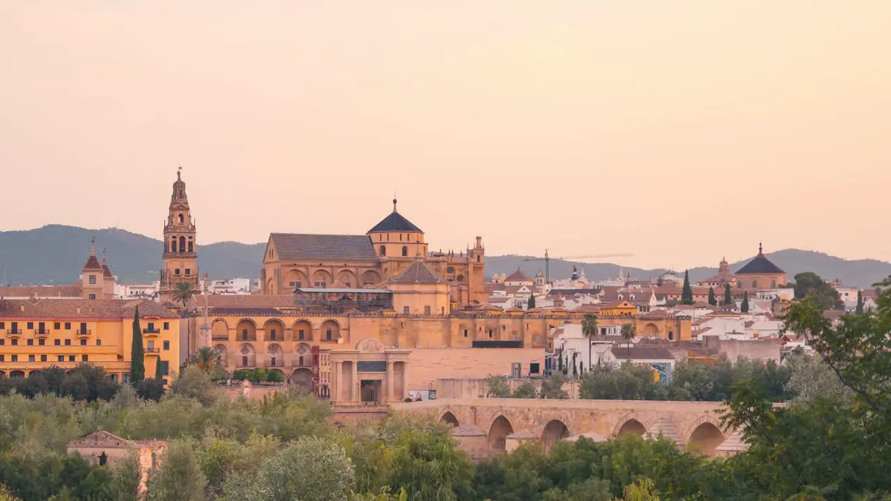 Close up Sunrise night to day timelapse of Cordoba Mezquita Mosque cathedral and roman bridge during summer