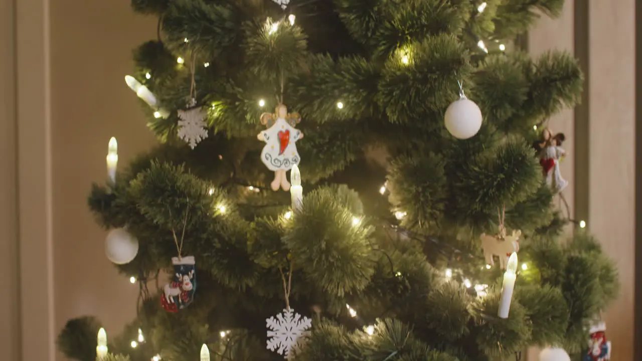 Camera Focuses On Christmas Tree Decorated With Christmas Elements Such As Angels Snowflakes And Balls