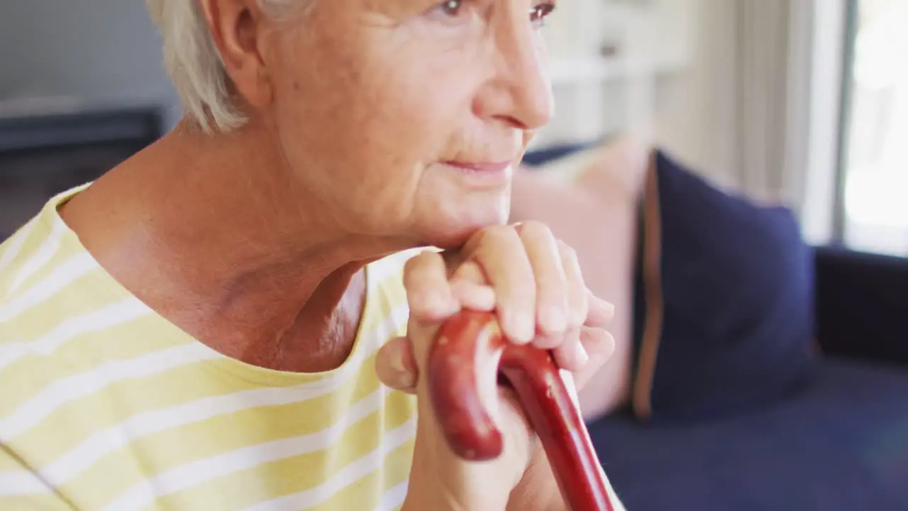 Video of thoughtful caucasian senior woman with walking stick