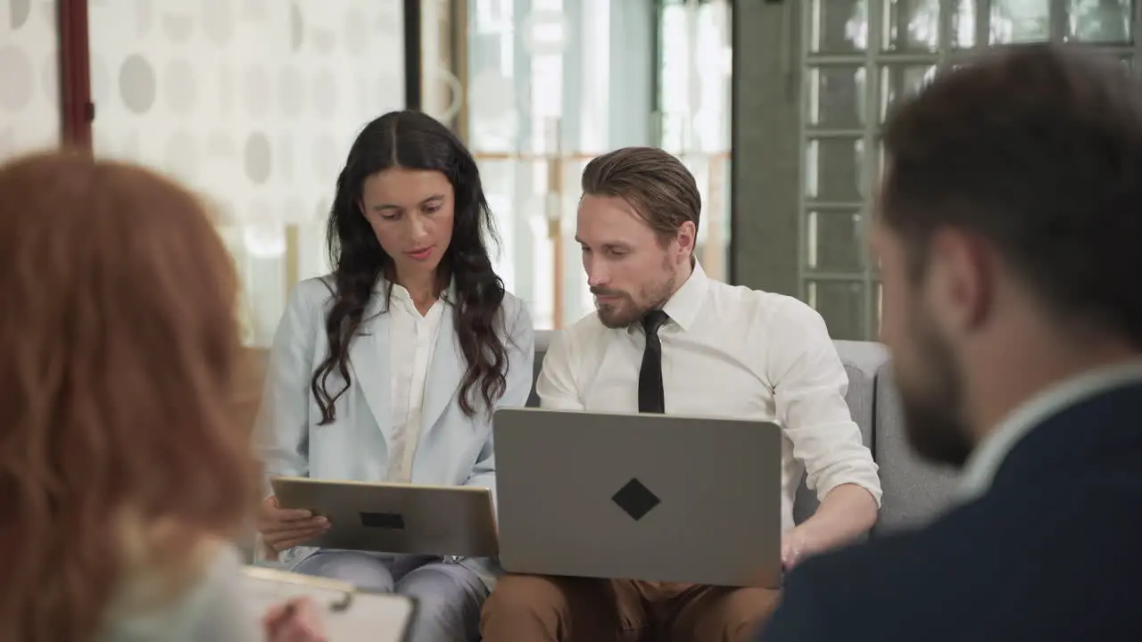 Business Meeting Between Two Women And Two Men At An Office 8