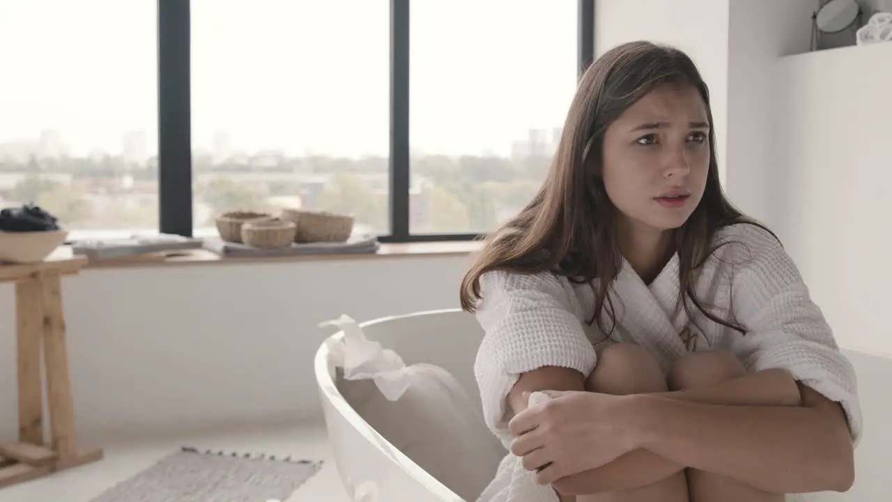 Sad Woman Crying While Sitting In The Bath In A Modern Bathroom At Home 1