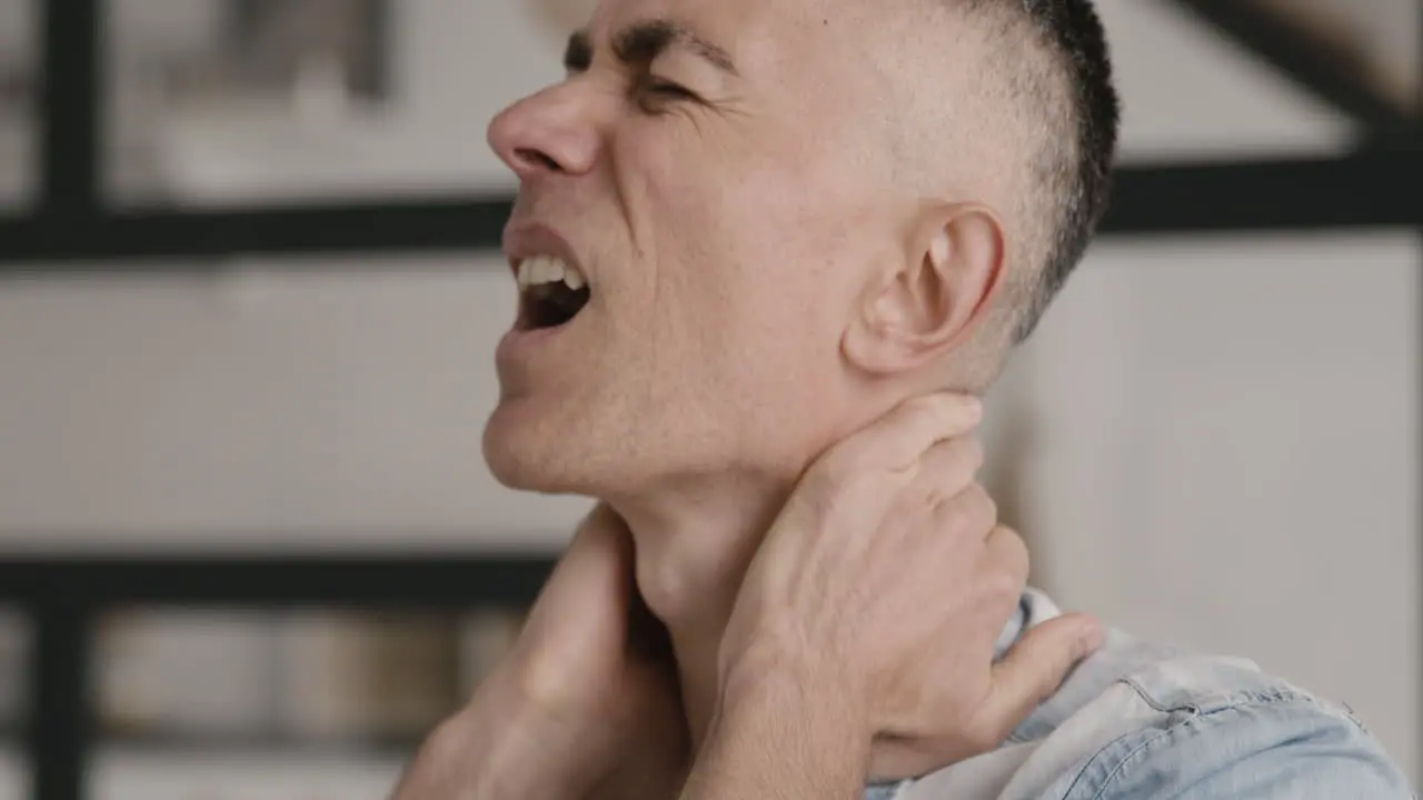 Middle Aged Man Having Neck Pain At Home