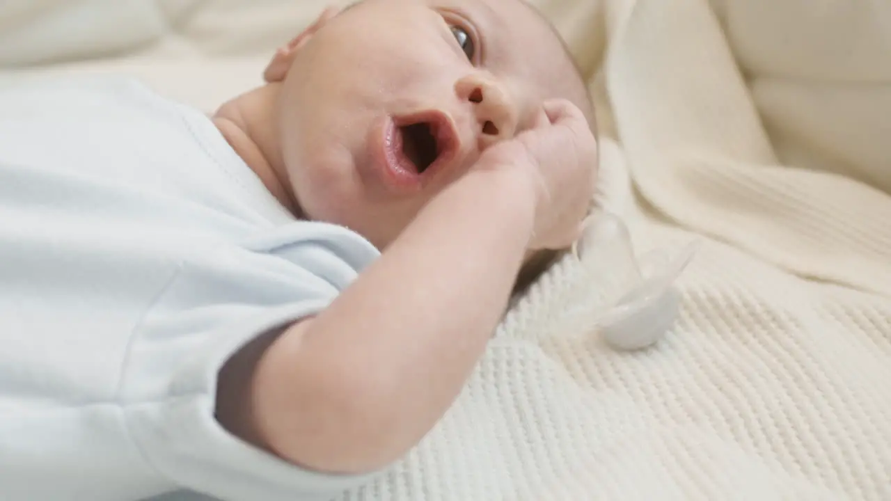 Close Up Of A Cute Newborn Baby Lying On Bed And Crying 3