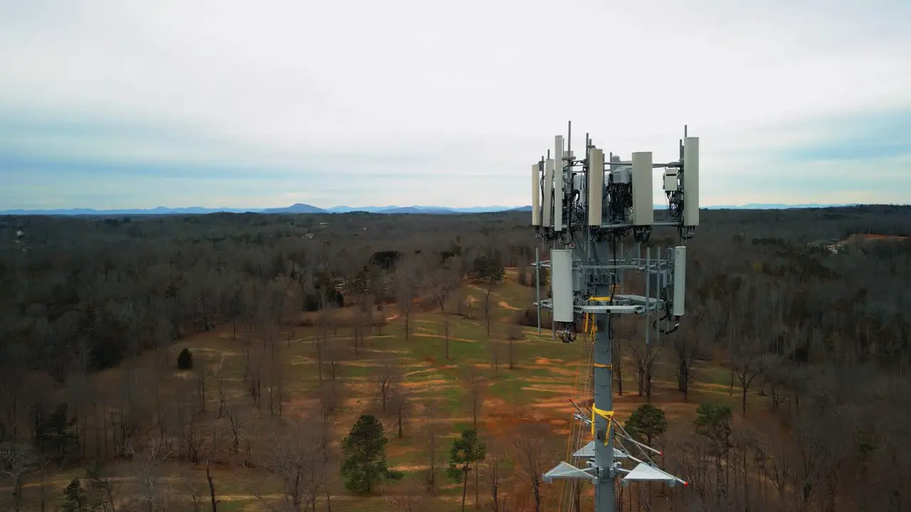 Aerial Reverse Shot of Cell Phone Tower Surrounded by Forest