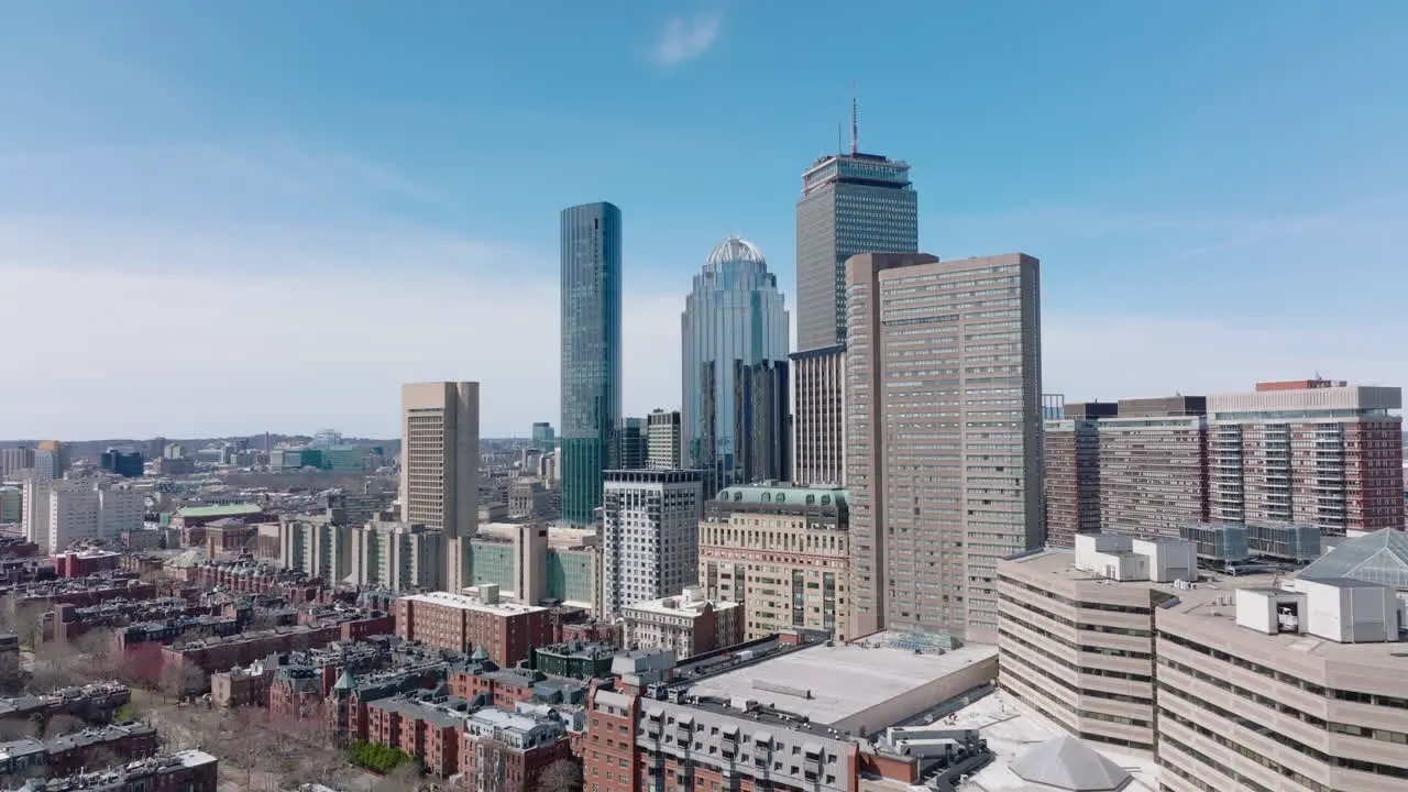 Group of high rise buildings office towers and hotel Glossy glass facade reflecting surrounding buildings Sunny day in metropolis Boston USA