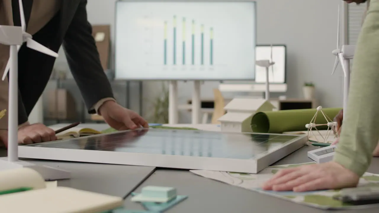 Close Up Of An Unrecognizable Team Discussing About Renewable Energy Project In The Office 1