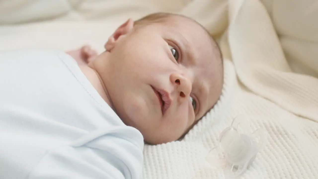 Close Up Of A Cute Newborn Baby Lying On Bed And Moving 1