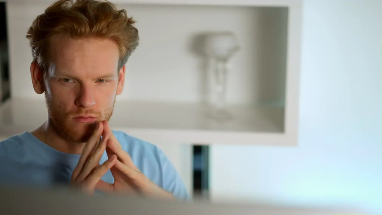 Closeup thoughtful businessman working on desktop computer making decision home