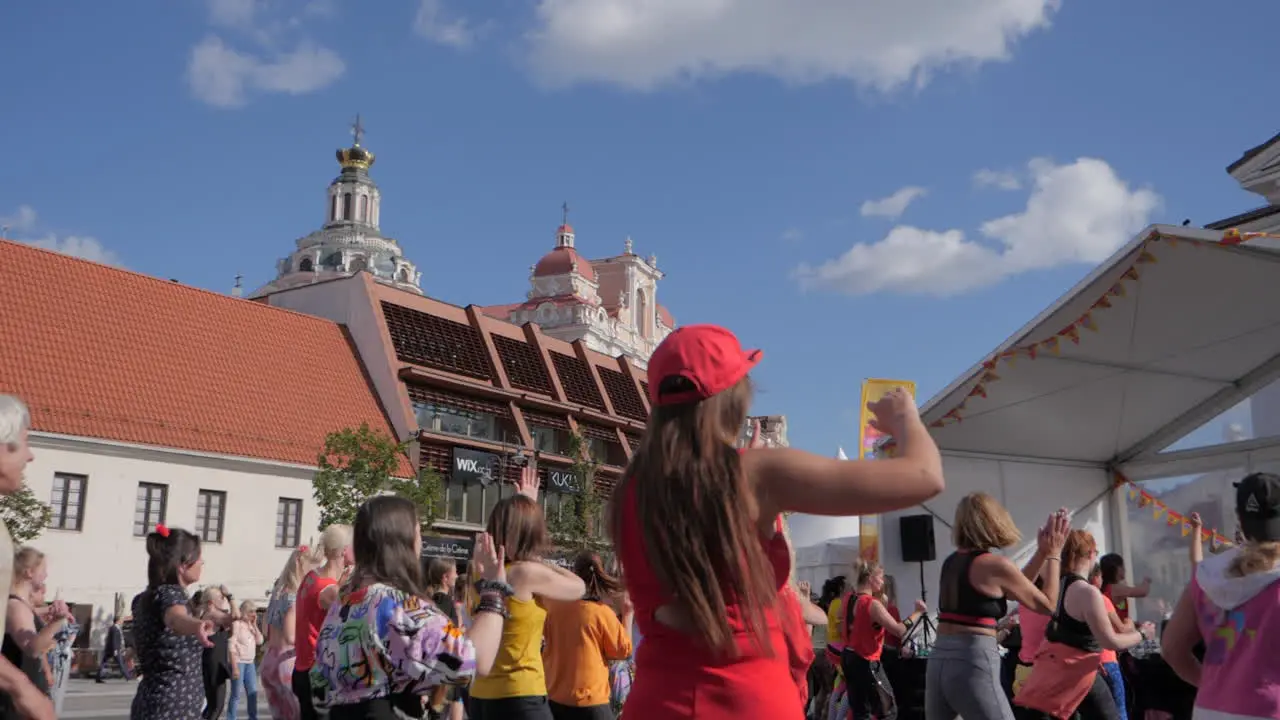 Many women latin dancing in city center slow motion