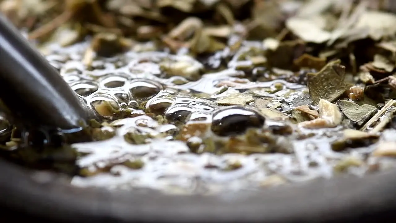 Pouring water into a "mate" gourd