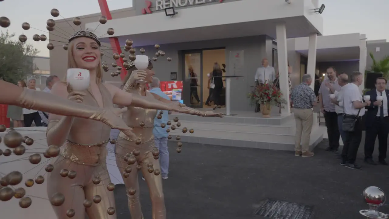 Slow motion shot of workers in abstract outfits welcoming guests to the party