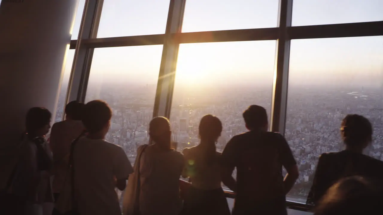 Silhouette Tourists taking Tokyo Skytree POV photos of the city in Slowmotion dreamy cinematic