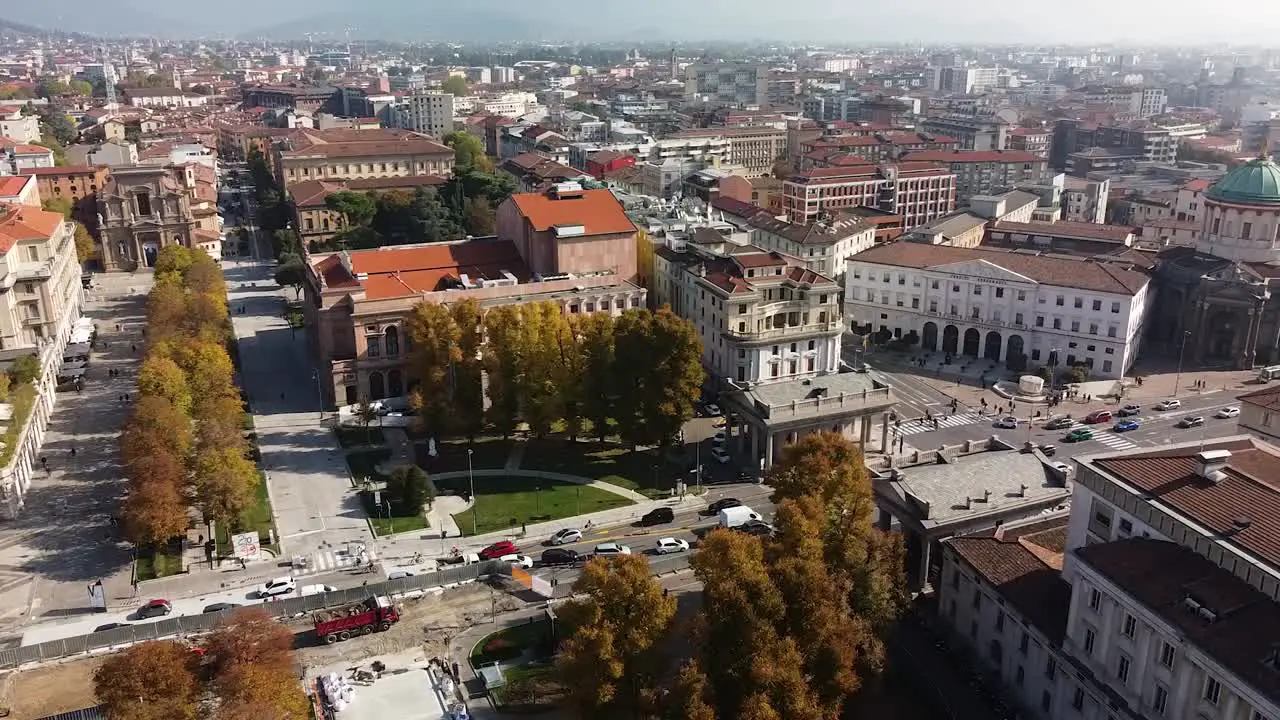 Rooftops of Bergamo city on warm sunny day aerial side fly view