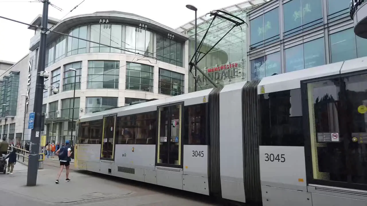 Facade of the Arndale shopping centre in Manchester and tram moving past Manchester UK