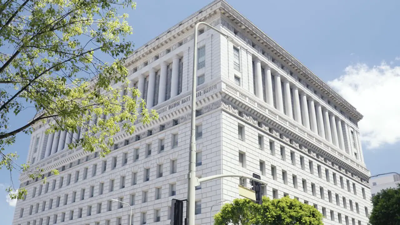 View onto the Hall of Justice in Los Angeles California USA during Summer time no camera movement steady frame with wind in tree leafes