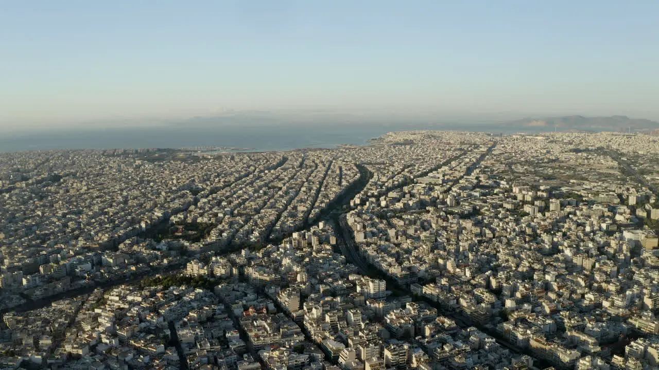 Drone aerial shot over the city of Athens with the Mediterranean Sea in the background Greece