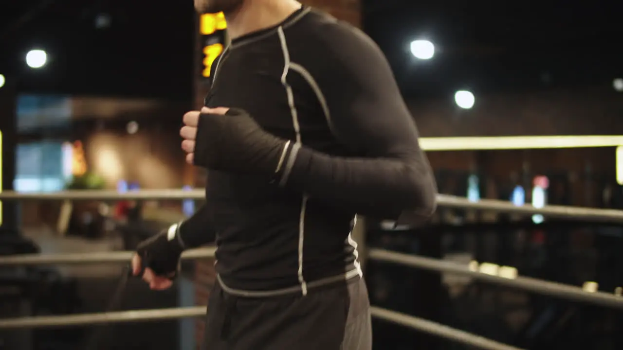 Active sport man using skipping rope at gym Boxer doing exercises on ring