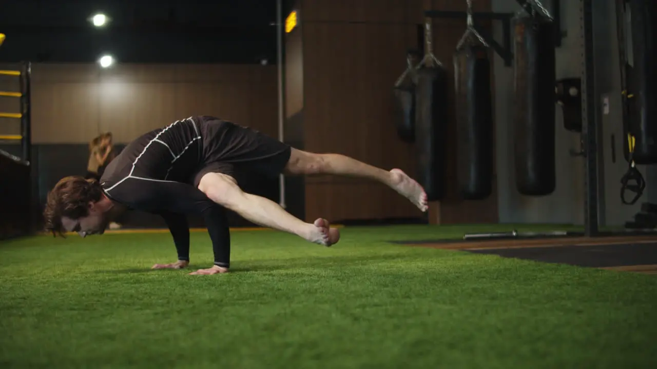 Focused fitness man doing stretching at gym Sport man exercising at gym