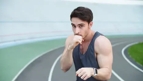 Man boxer exercising at stadium Sport man boxing in slow motion outdoor