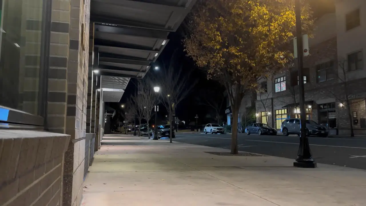 Downtown Ashland Oregon at night as cars drive by