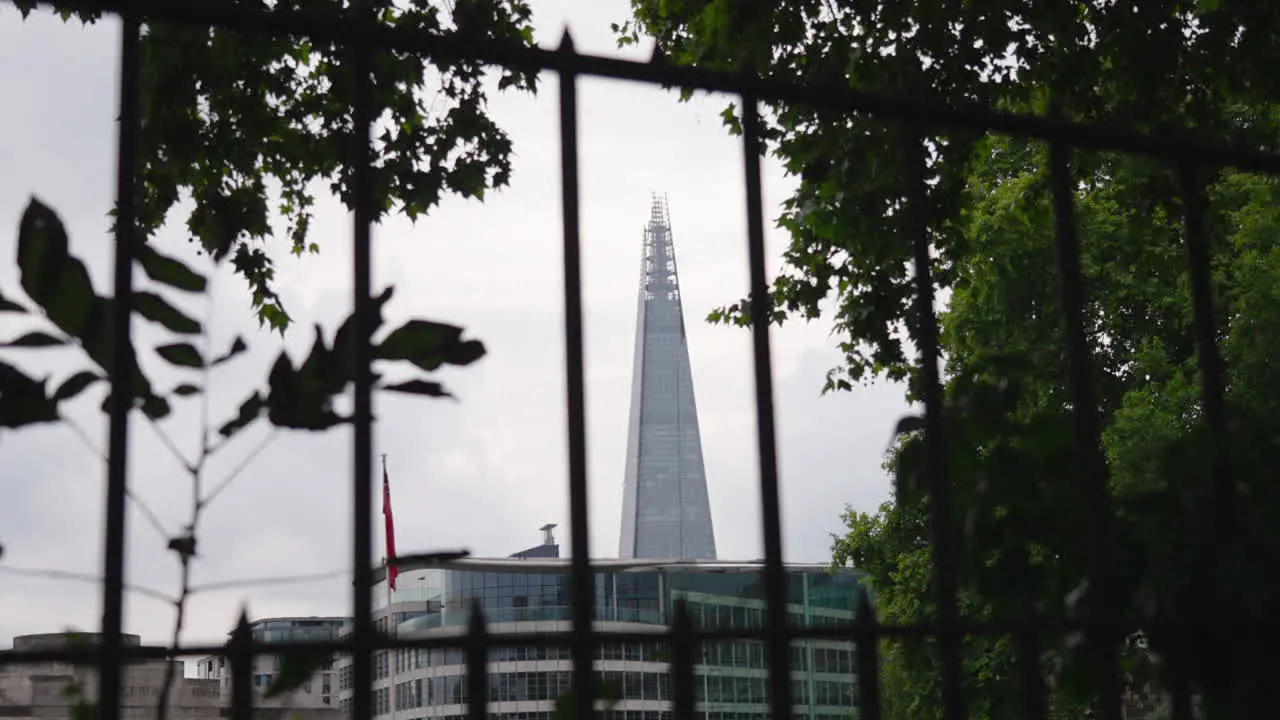 The Shard tallest tower in London UK ground level static shot through steel railings