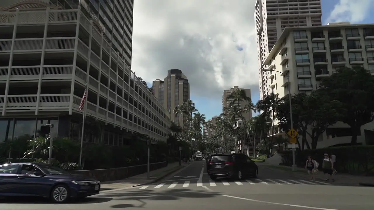 Downtown street and cityscape low angle view in Ala Wai Boulevard in Oahu Hawaii Wide tilt up shot