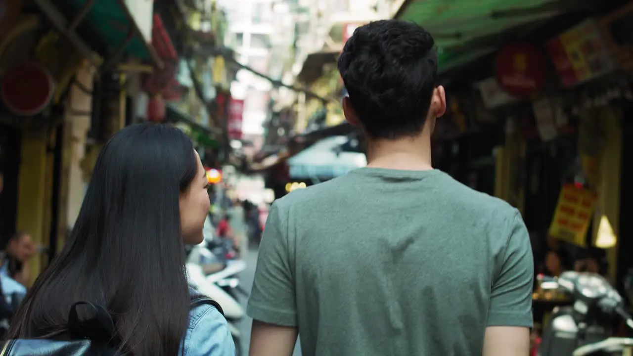 Handheld view of Vietnamese couple sightseeing