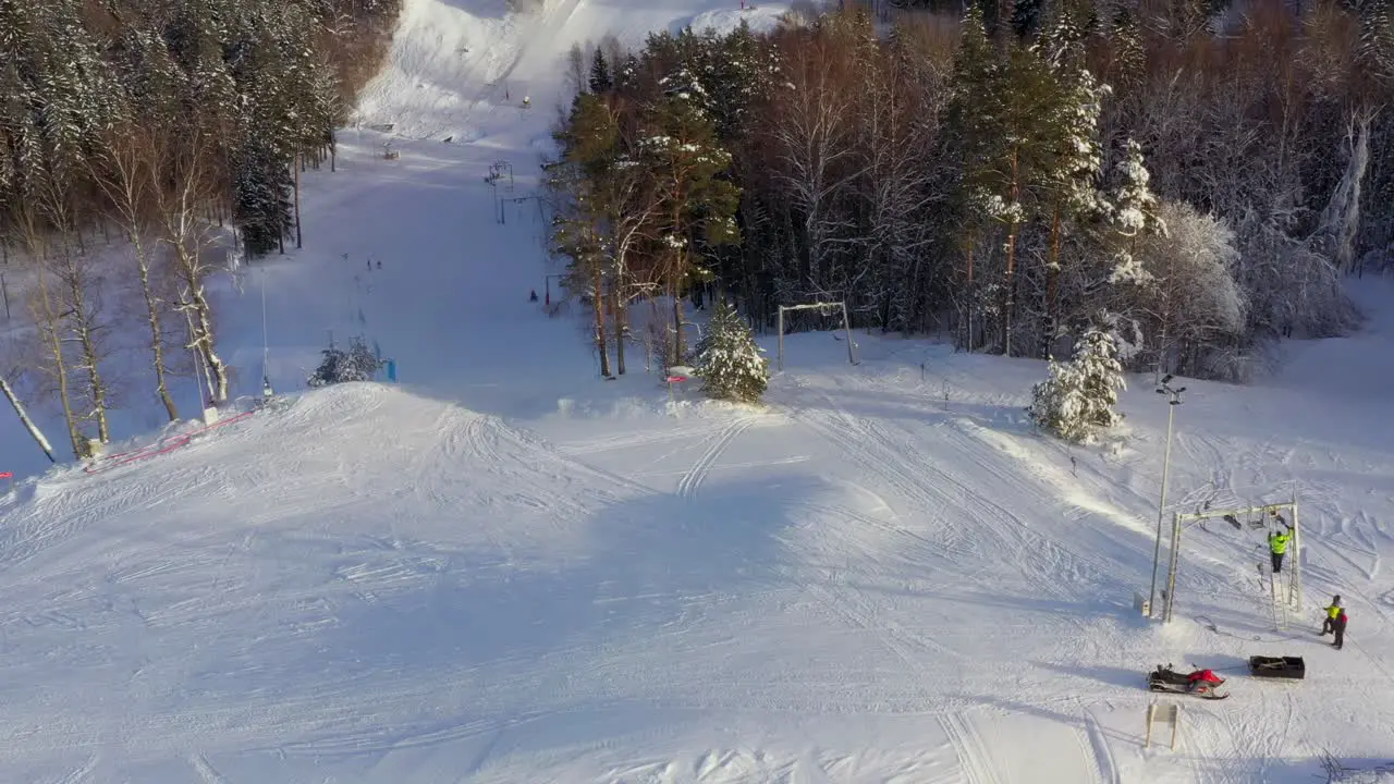 Drone panning to left and revealing beautiful snowy Kütiorg mountain in Võrumaa