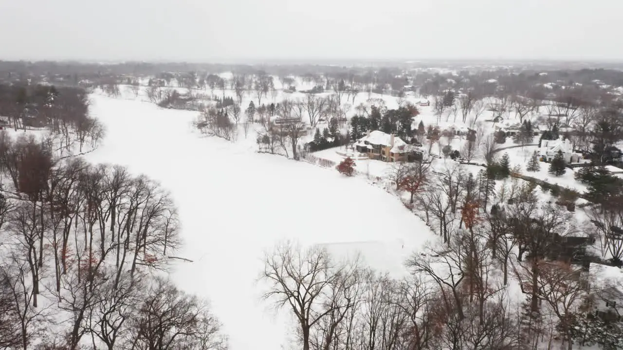 Aerial homemade ice skating rink on a frozen backyard pond during winter