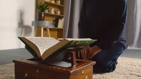 Close Up Of Muslim Woman At Home Kneeling And Reciting From The Quran 3