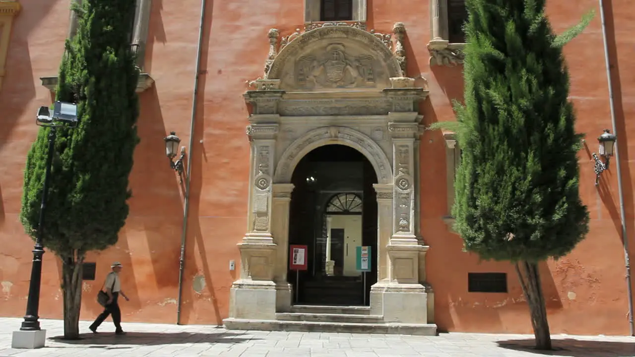 Granada cathedral door with a man walking in